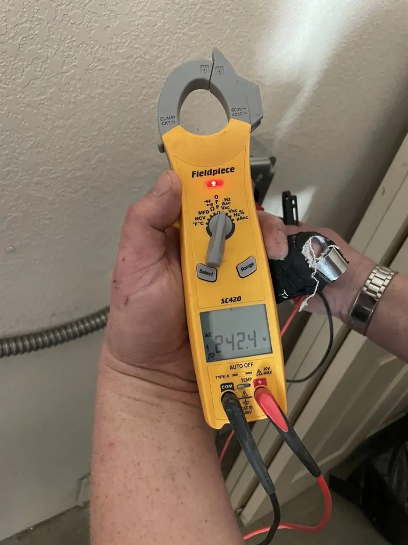 Voltage testing with clamp meter during Aluminum Wiring Replacement in Burns